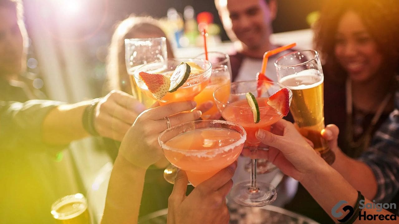 people toasting with their cocktails at a party